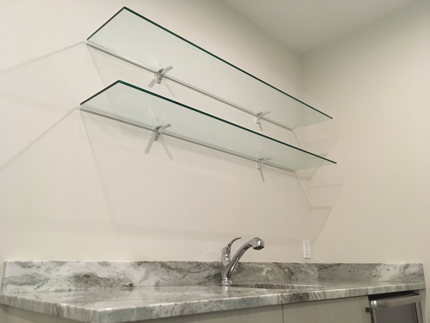 Glass shelving in a modern kitchen